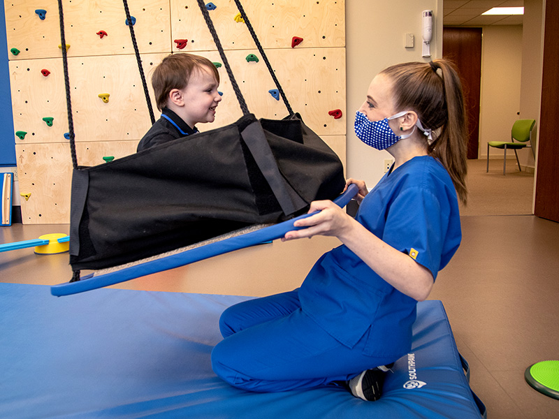 Mary Lowry Vollema, occupational therapist, works with Justin Youngblood of Pearl, an ASD patient, at the Center for Advancement of Youth.